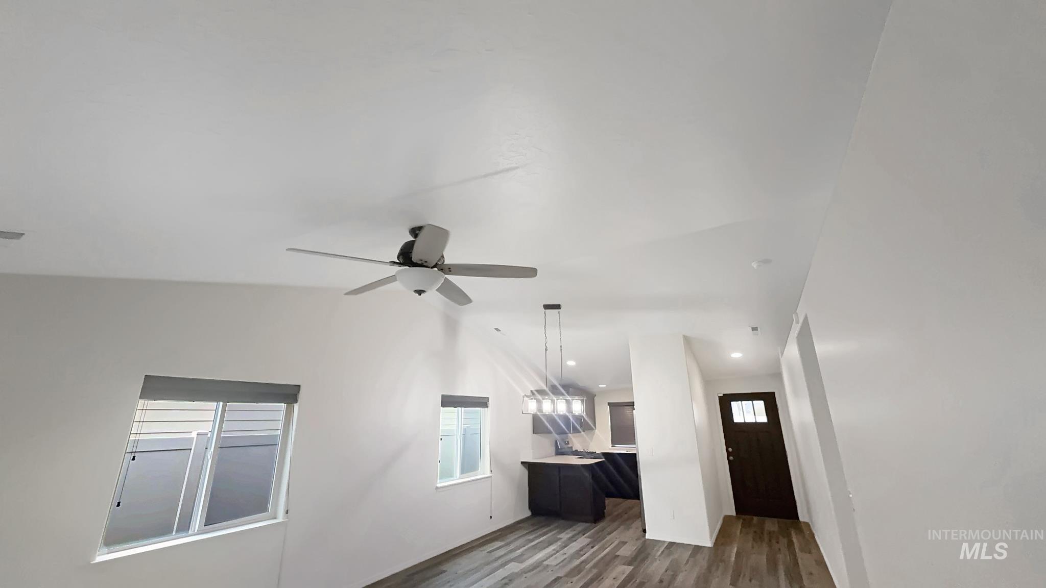 5223 Junegrass Way Caldwell, ID 83607 - Photo 9 of 16 Unfurnished living room featuring dark wood-style floors, recessed lighting, and a ceiling fan