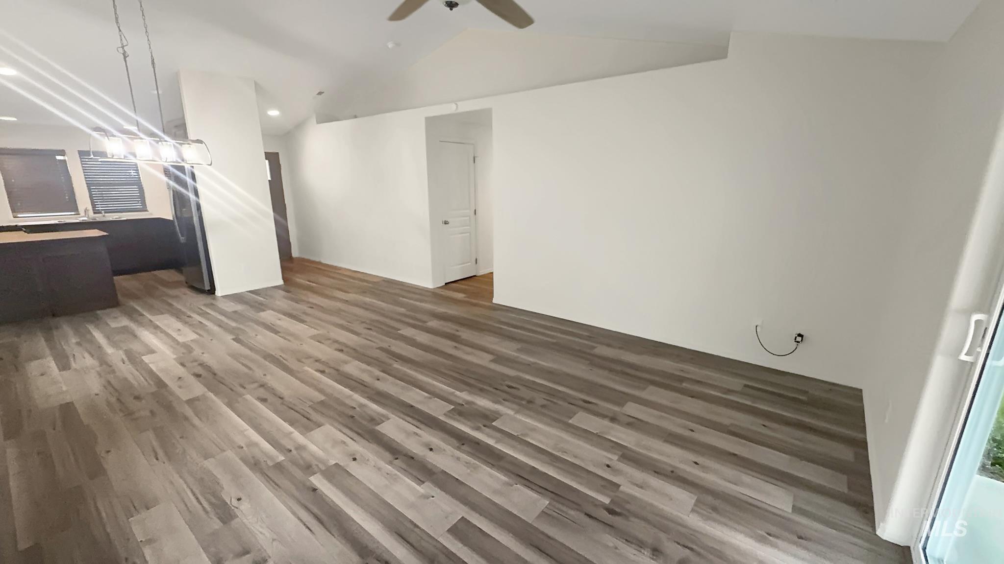 5223 Junegrass Way Caldwell, ID 83607 - Photo 10 of 16 Unfurnished living room featuring wood finished floors, recessed lighting, a ceiling fan, and vaulted ceiling