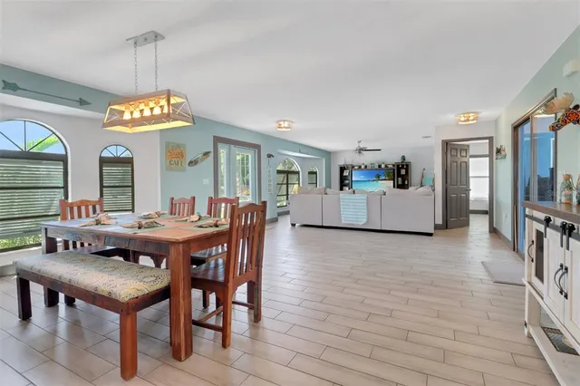 a living room with furniture a flat screen tv and a large window