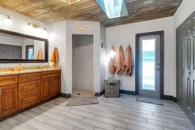 a bathroom with a tub sink and mirror