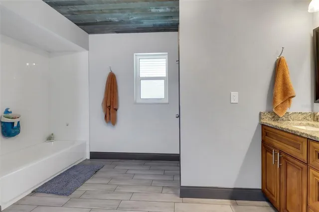a bedroom with bed and a book shelf