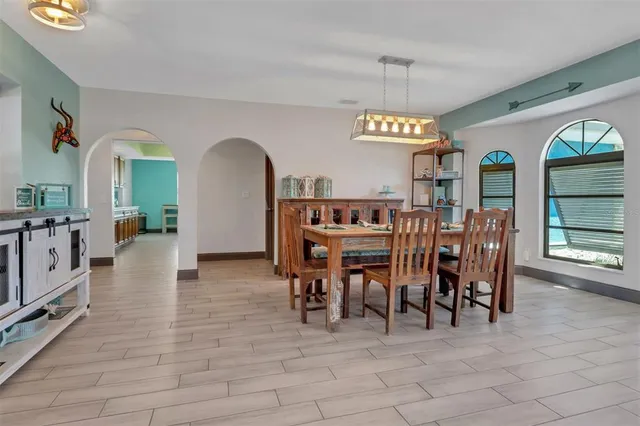 a view of a dining room with furniture and window