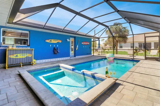 a view of swimming pool with chairs and yard