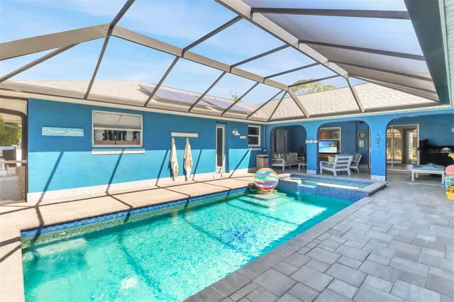 a view of a patio with table and chairs potted plants and palm tree