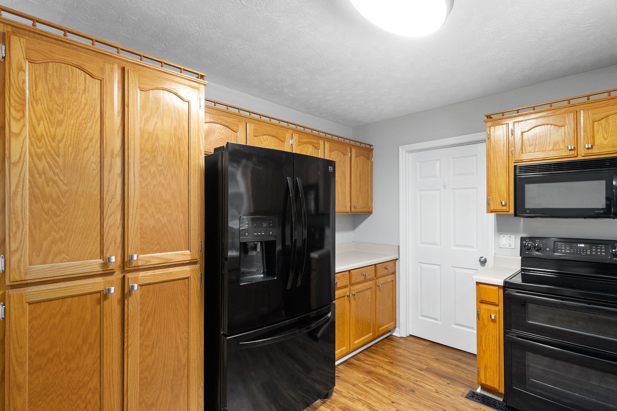 1011 Cherokee Trail Springfield, TN 37172 - Photo 15 of 40 a kitchen with a refrigerator and a stove top oven