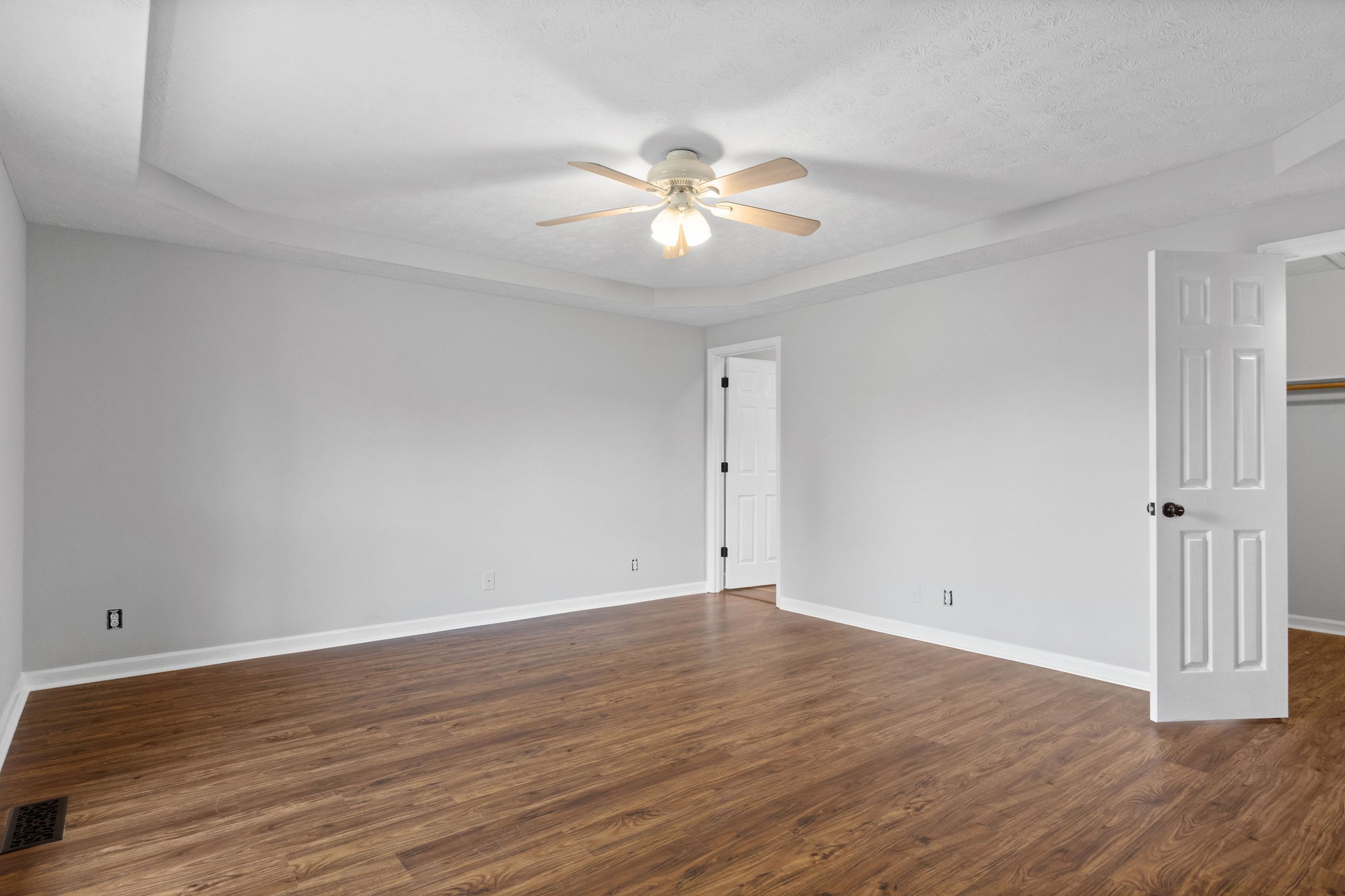 1011 Cherokee Trail Springfield, TN 37172 - Photo 17 of 40 a view of an empty room with wooden floor and a ceiling fan