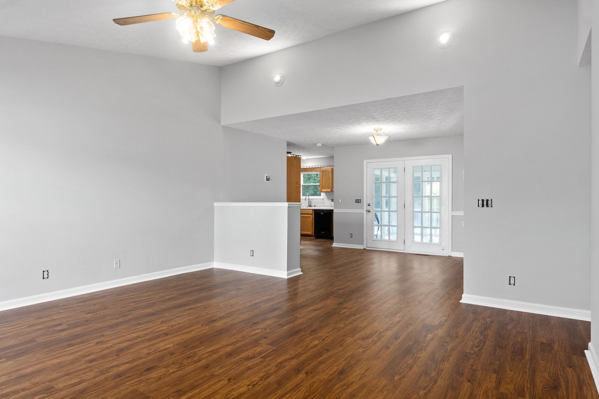 1011 Cherokee Trail Springfield, TN 37172 - Photo 6 of 40 an empty room with wooden floor and windows