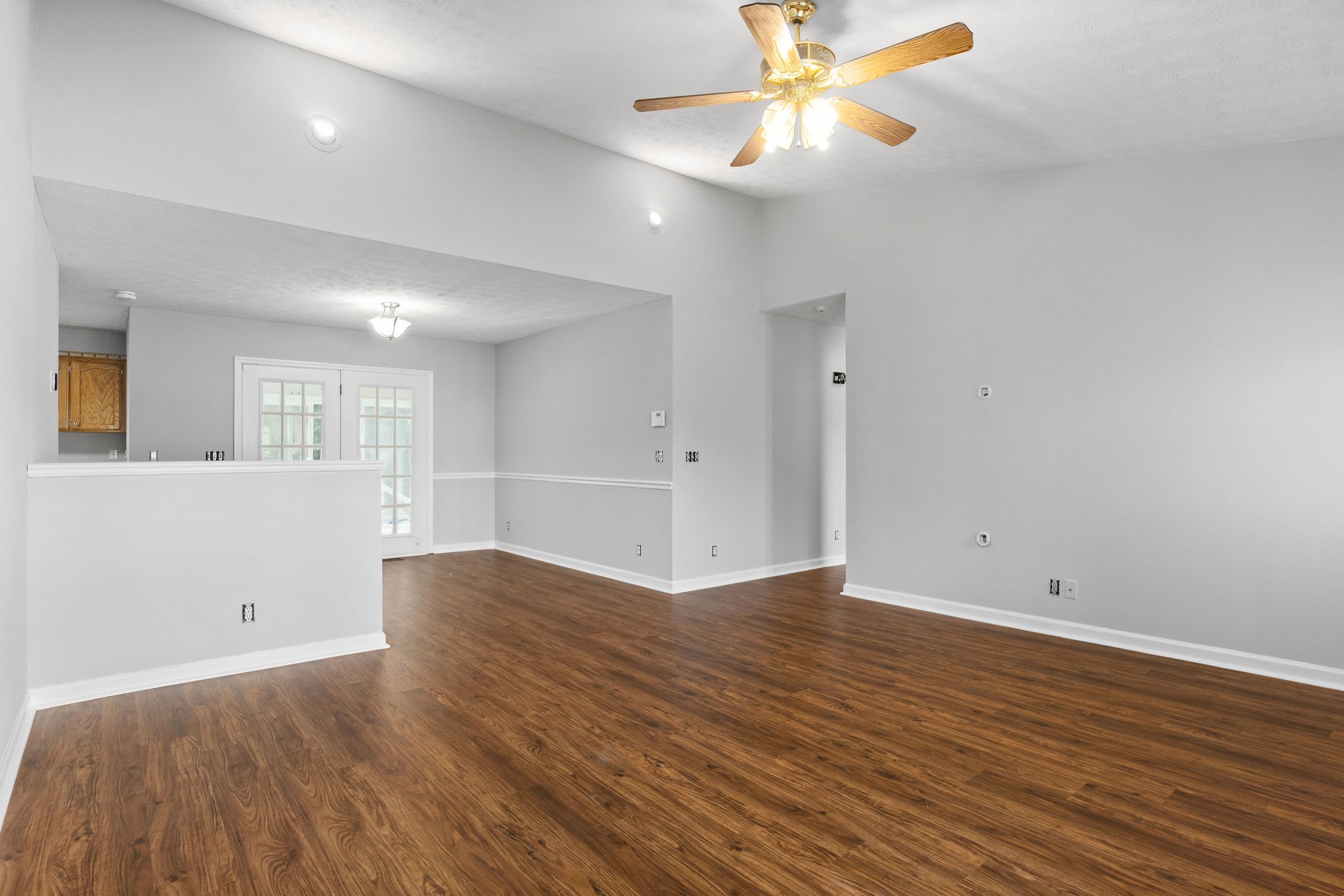 1011 Cherokee Trail Springfield, TN 37172 - Photo 7 of 40 an empty room with wooden floor and windows