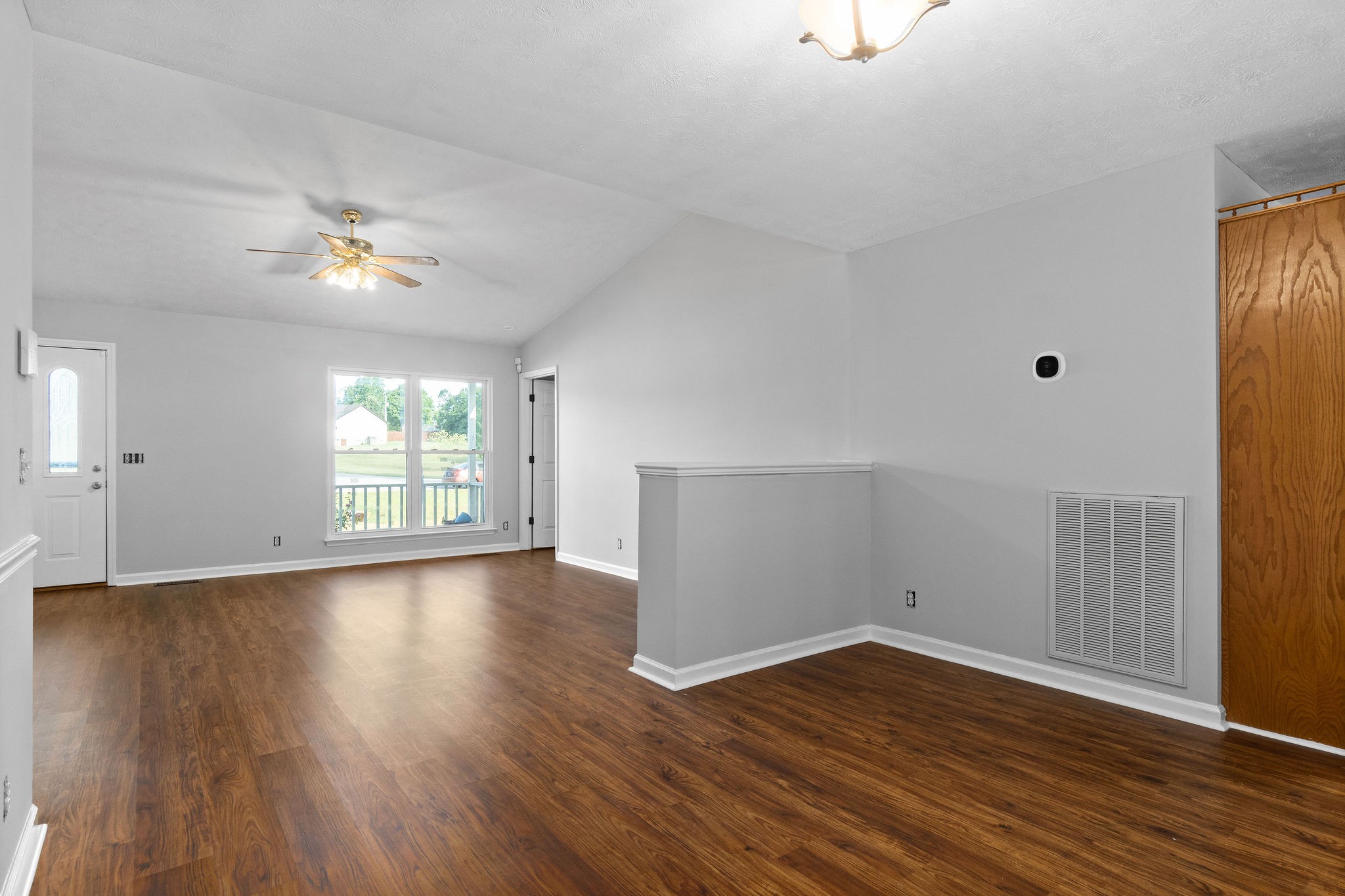 1011 Cherokee Trail Springfield, TN 37172 - Photo 9 of 40 a view of an empty room with wooden floor and a window