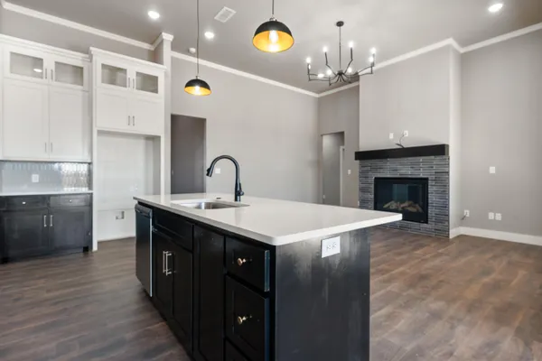 a kitchen with a sink and chandelier