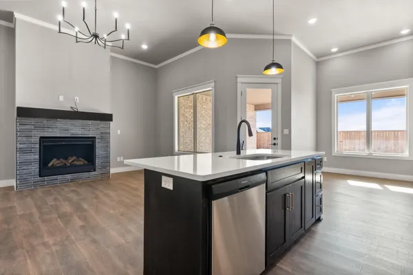 a kitchen with a sink and a stove next to a window