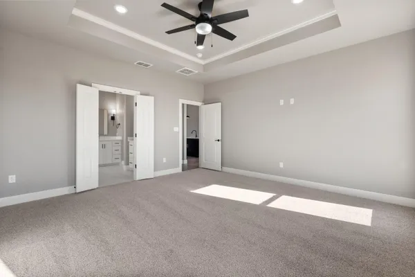 a view of an empty room and kitchen view