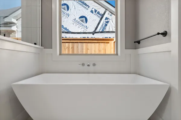 a white bath tub sitting next to a window
