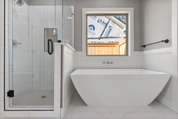 a bathroom with a tub and a shower