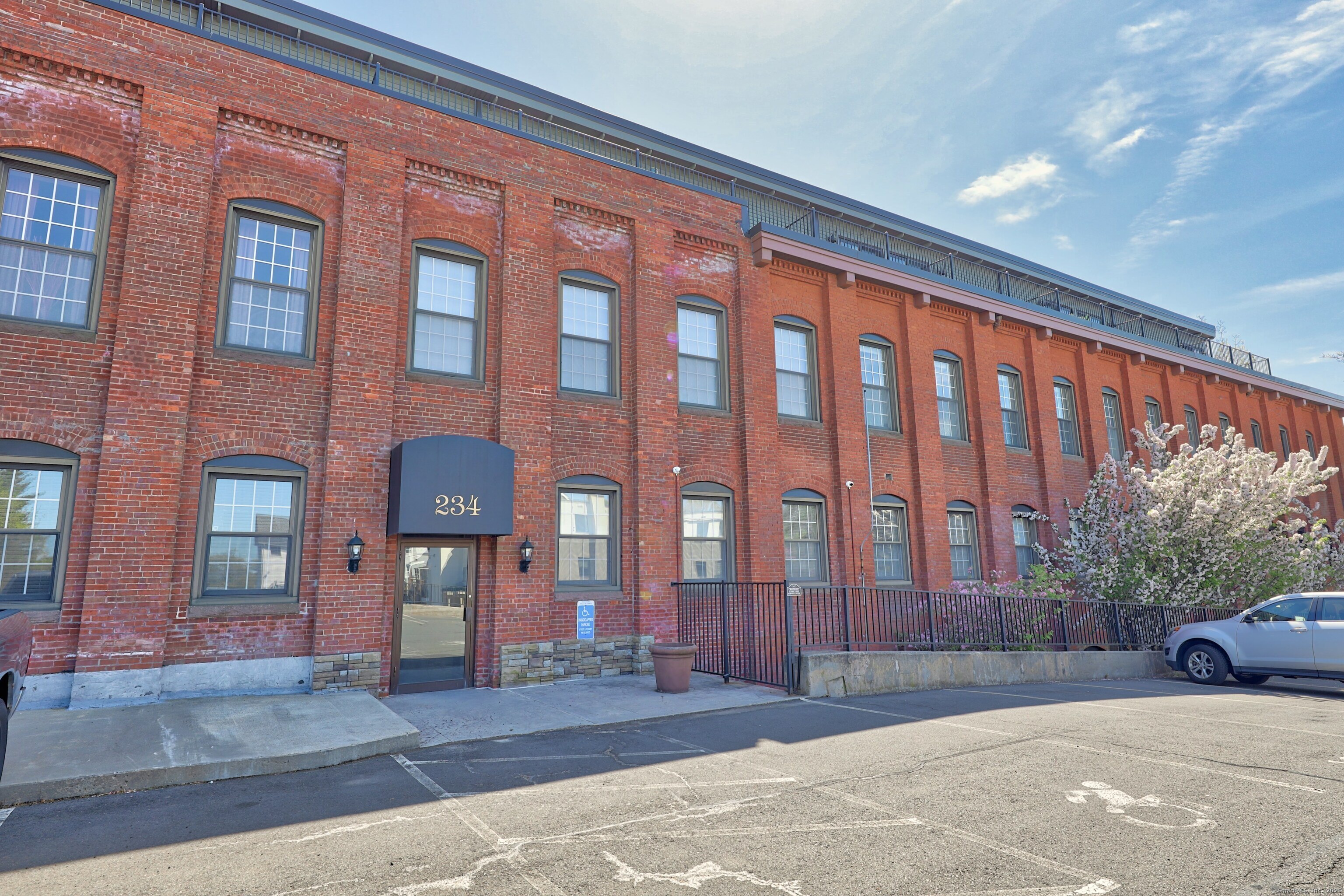 234 South Main Street, Unit 410 Middletown, CT 06457 - Photo 1 of 20 a front view of a building with a garden