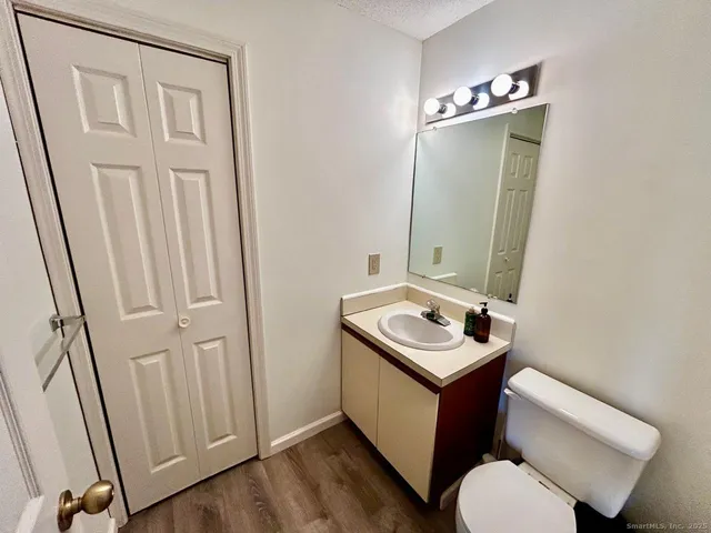 a bathroom with a sink toilet and mirror