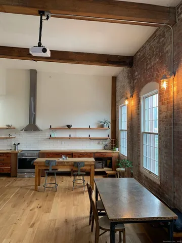 a room with furniture pool table and windows