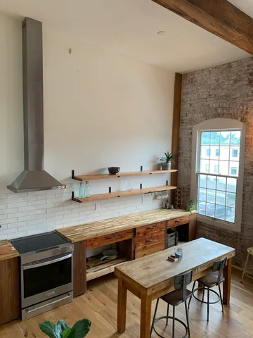 a kitchen with a sink cabinets and window