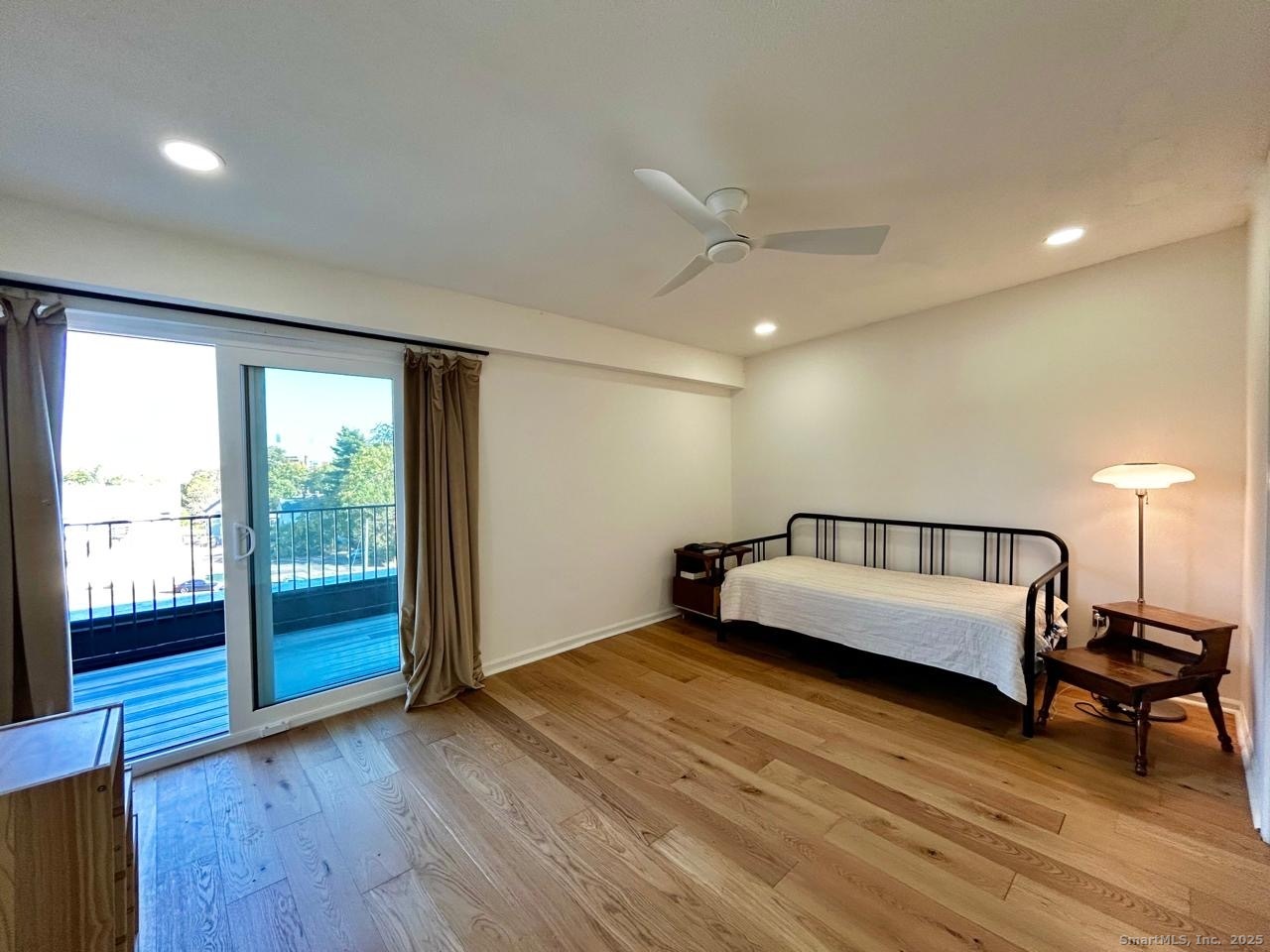 234 South Main Street, Unit 410 Middletown, CT 06457 - Photo 9 of 20 a spacious bedroom with a bed and wooden floor