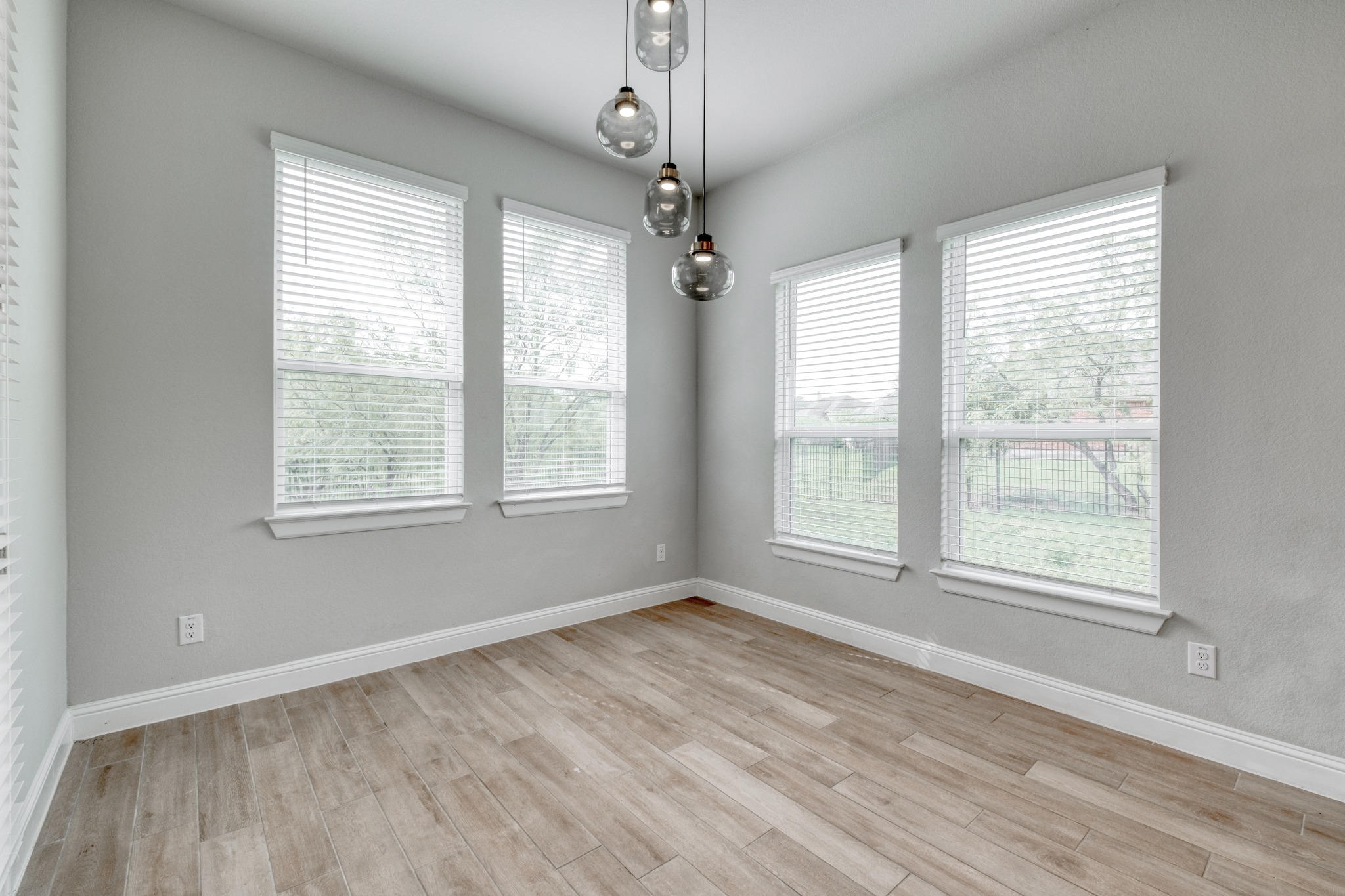 359 Raptor Beak Way Cedar Creek, TX 78612 - Photo 11 of 29 a view of an empty room with wooden floor and a window