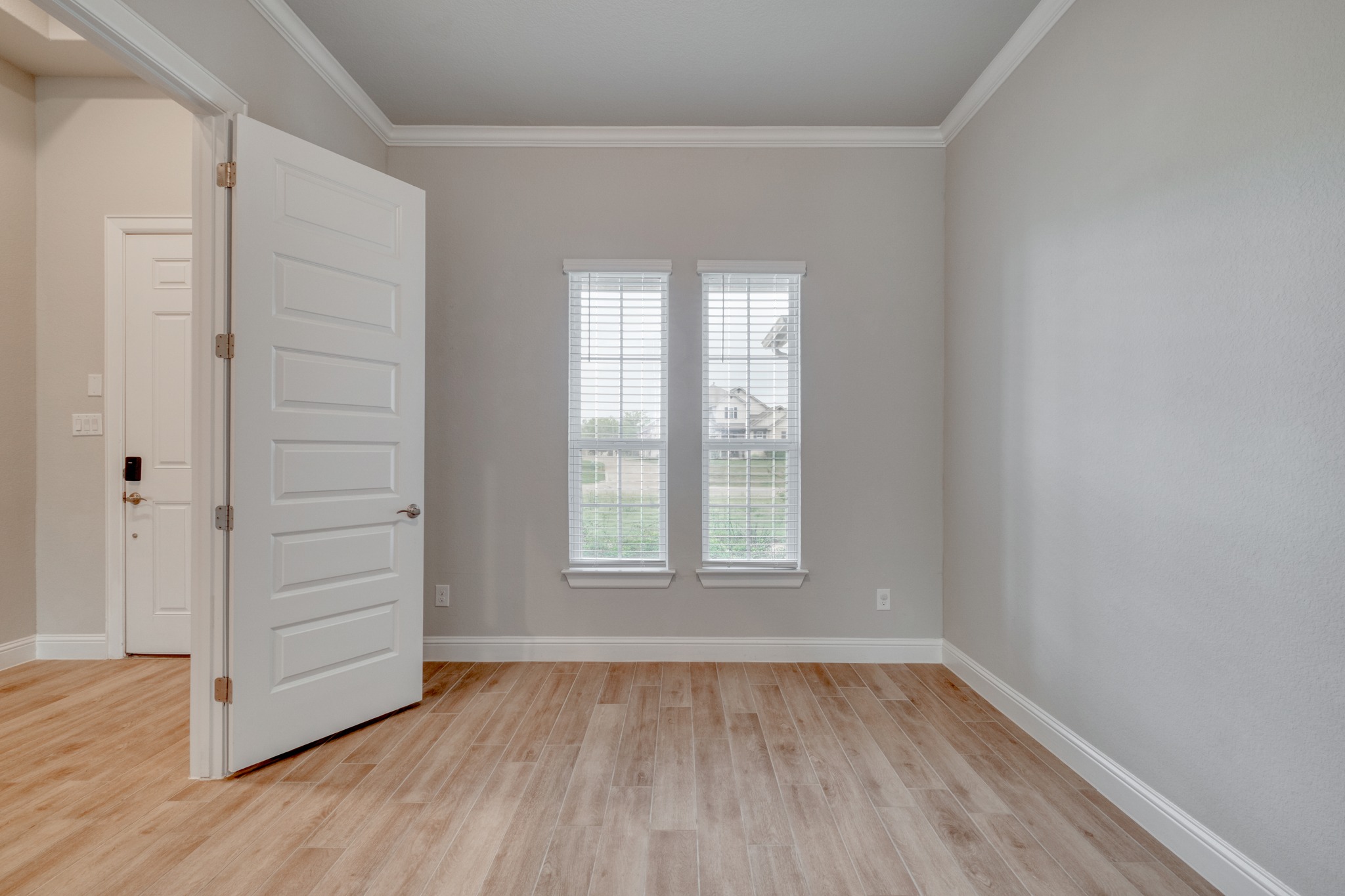 359 Raptor Beak Way Cedar Creek, TX 78612 - Photo 14 of 29 an empty room with wooden floor closet and windows