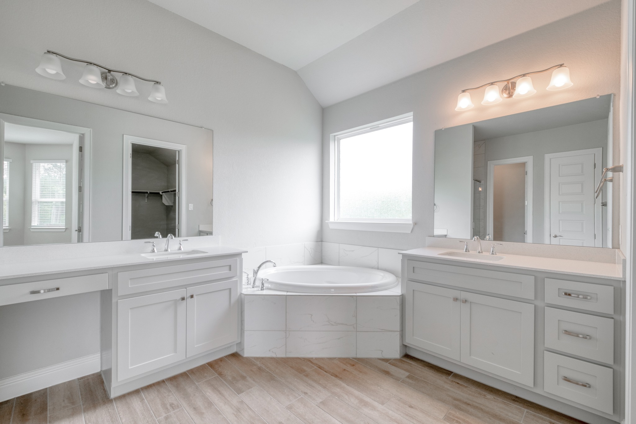 359 Raptor Beak Way Cedar Creek, TX 78612 - Photo 18 of 29 a bathroom with a double vanity sink a mirror and a bathtub