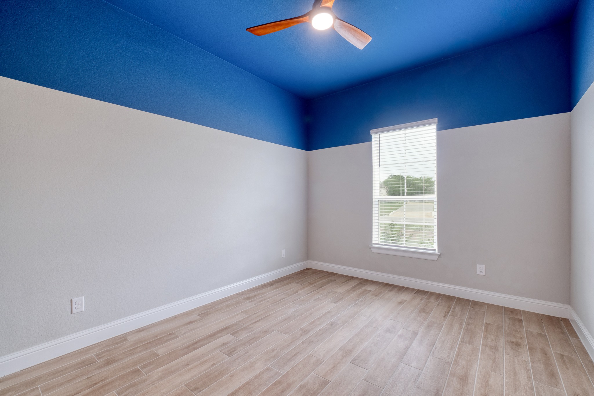 359 Raptor Beak Way Cedar Creek, TX 78612 - Photo 21 of 29 an empty room with wooden floor and windows