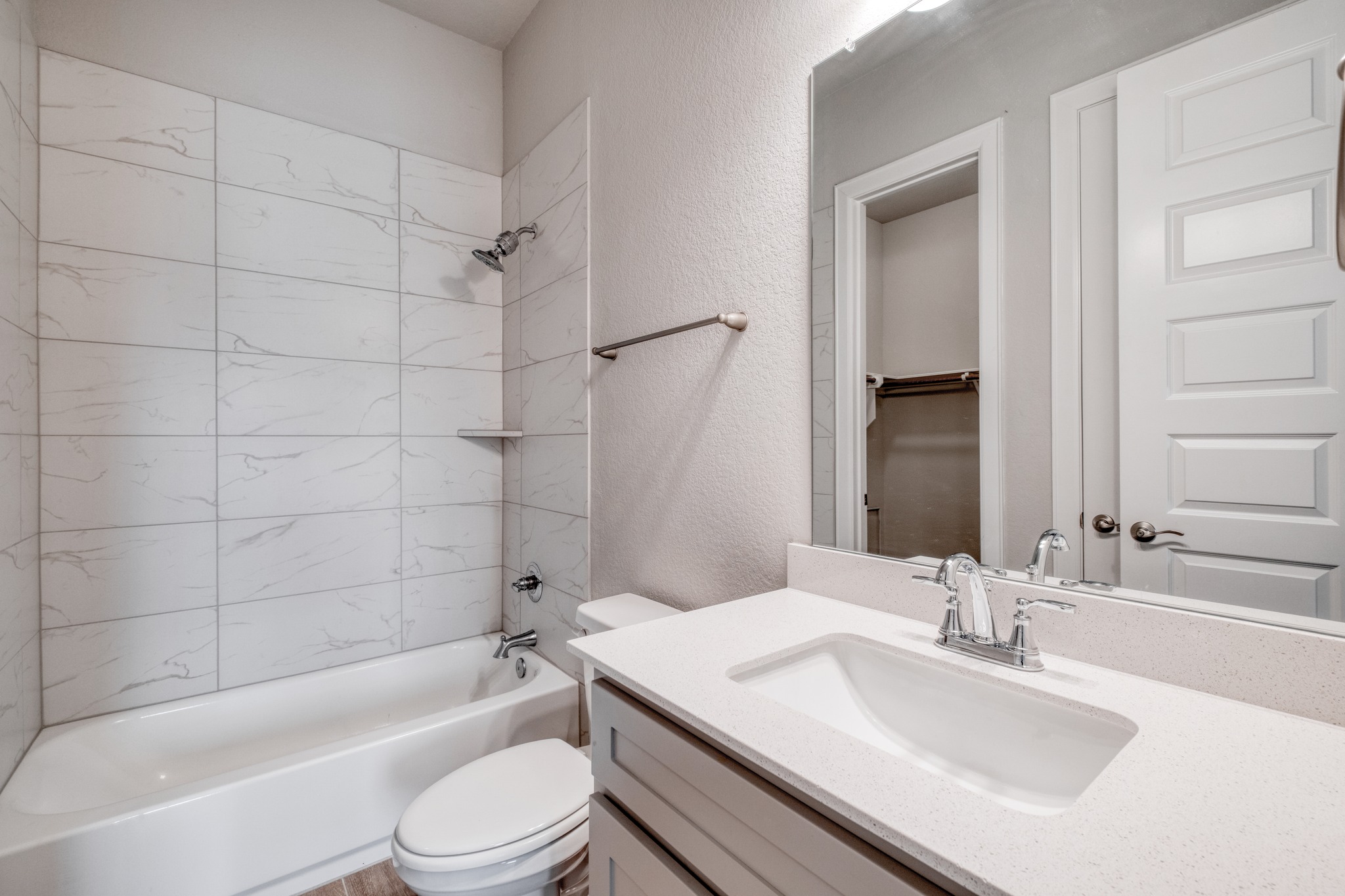 359 Raptor Beak Way Cedar Creek, TX 78612 - Photo 22 of 29 a bathroom with a bathtub shower sink vanity mirror and toilet