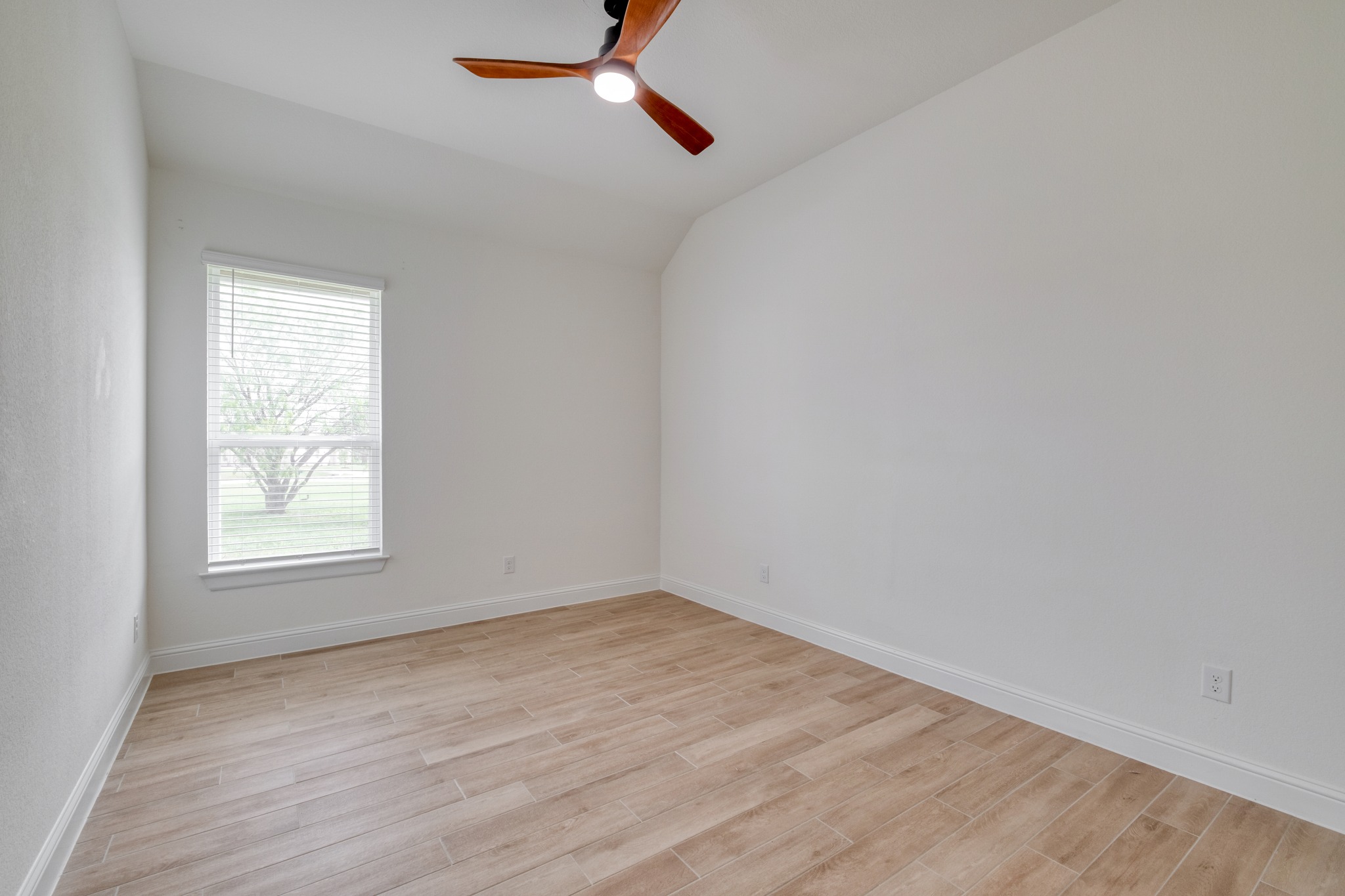 359 Raptor Beak Way Cedar Creek, TX 78612 - Photo 23 of 29 an empty room with wooden floor and windows
