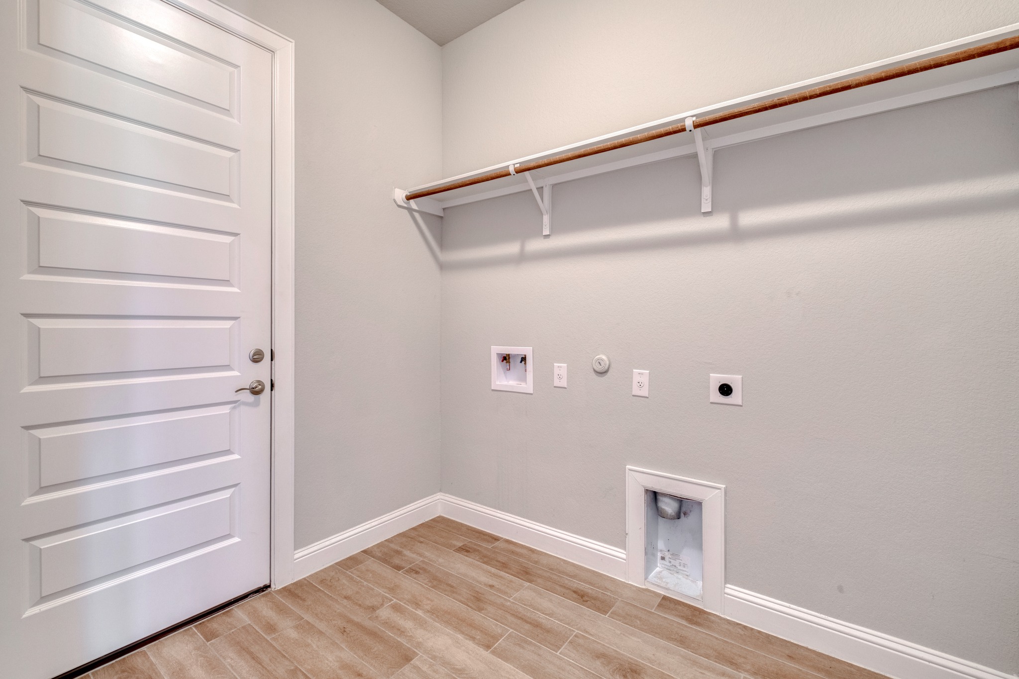 359 Raptor Beak Way Cedar Creek, TX 78612 - Photo 27 of 29 a view of an empty room with wooden floor