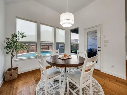 a view of a dining room with furniture window and wooden floor