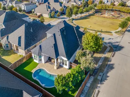 an aerial view of a house with a swimming pool