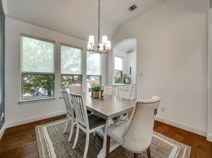 a view of a dining room with furniture wooden floor and chandelier