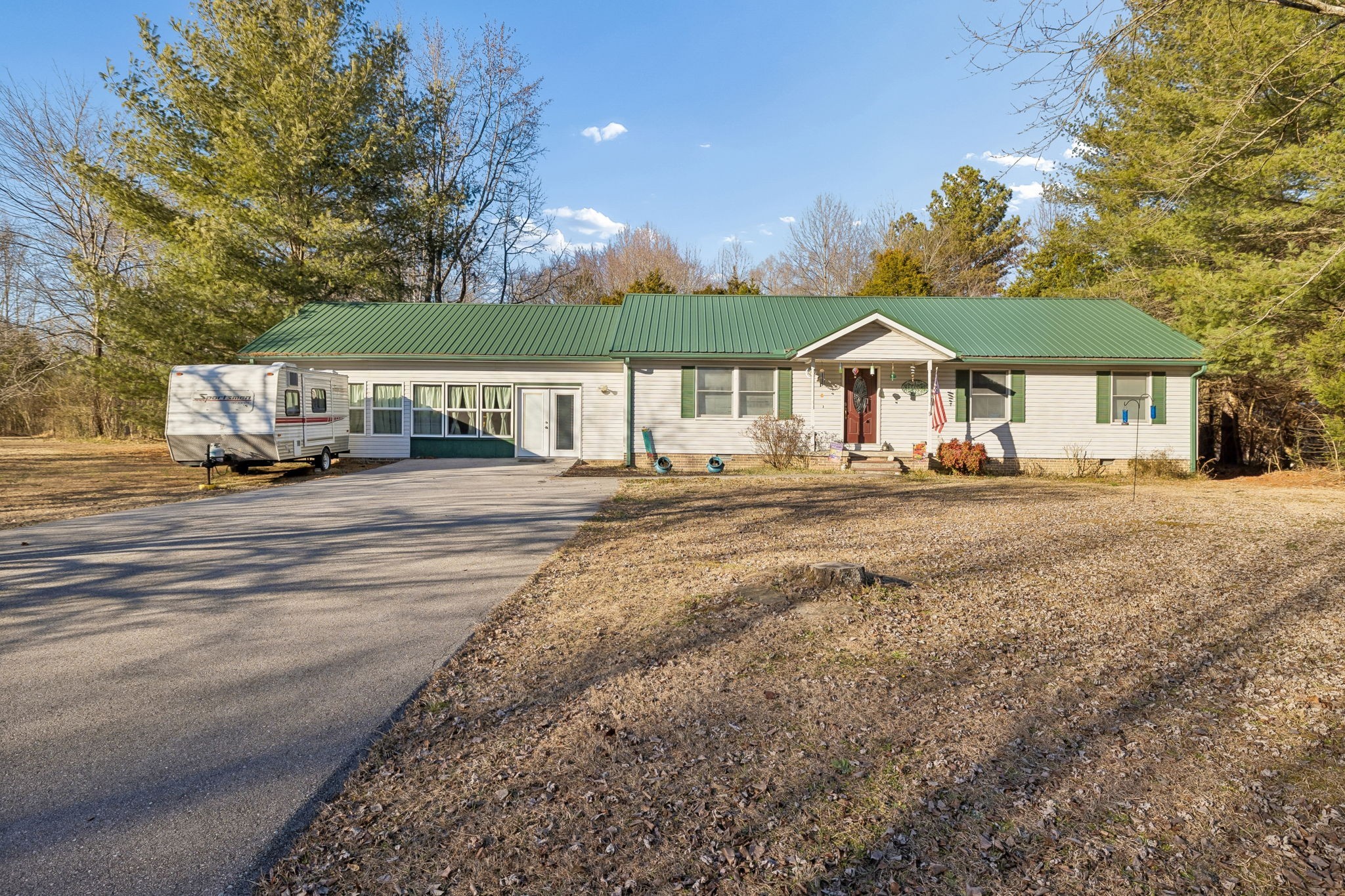 330 Deerfield Road Sparta, TN 38583 - Photo 1 of 34 a front view of a house with a yard street and trees