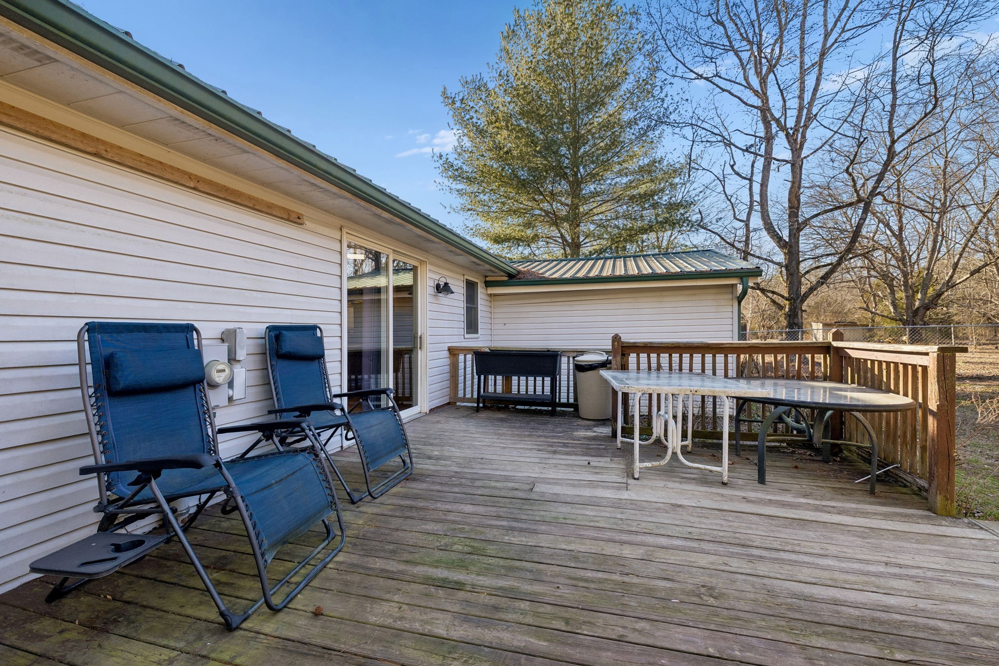 330 Deerfield Road Sparta, TN 38583 - Photo 31 of 34 a view of a patio with table and chairs and barbeque potted plants and large tree
