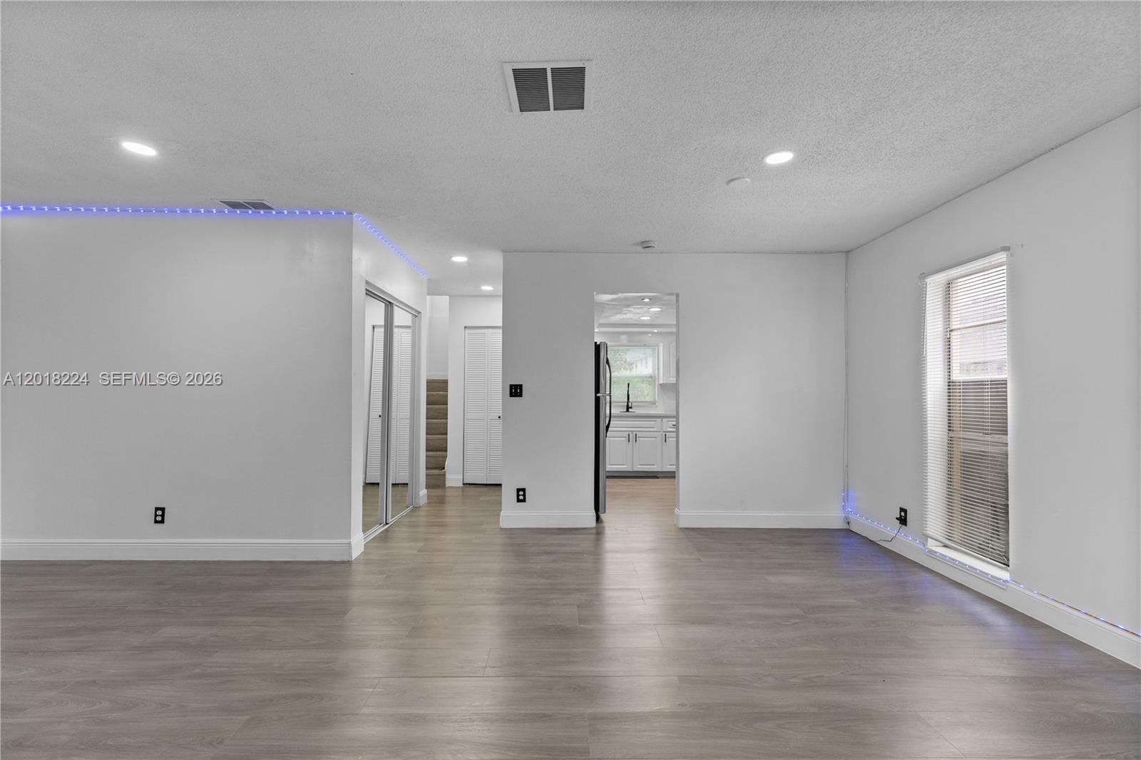 7958 Southwest 6th Street Pompano Beach, FL 33068 - Photo 11 of 57 a view of an empty room with wooden floor and a bathroom