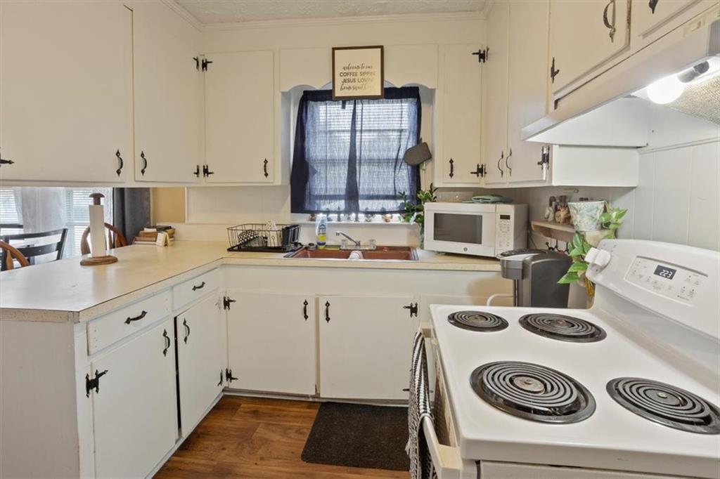 2523 Maple Road Southeast Rome, GA 30161 - Photo 13 of 30 a kitchen with a sink a stove and white cabinets