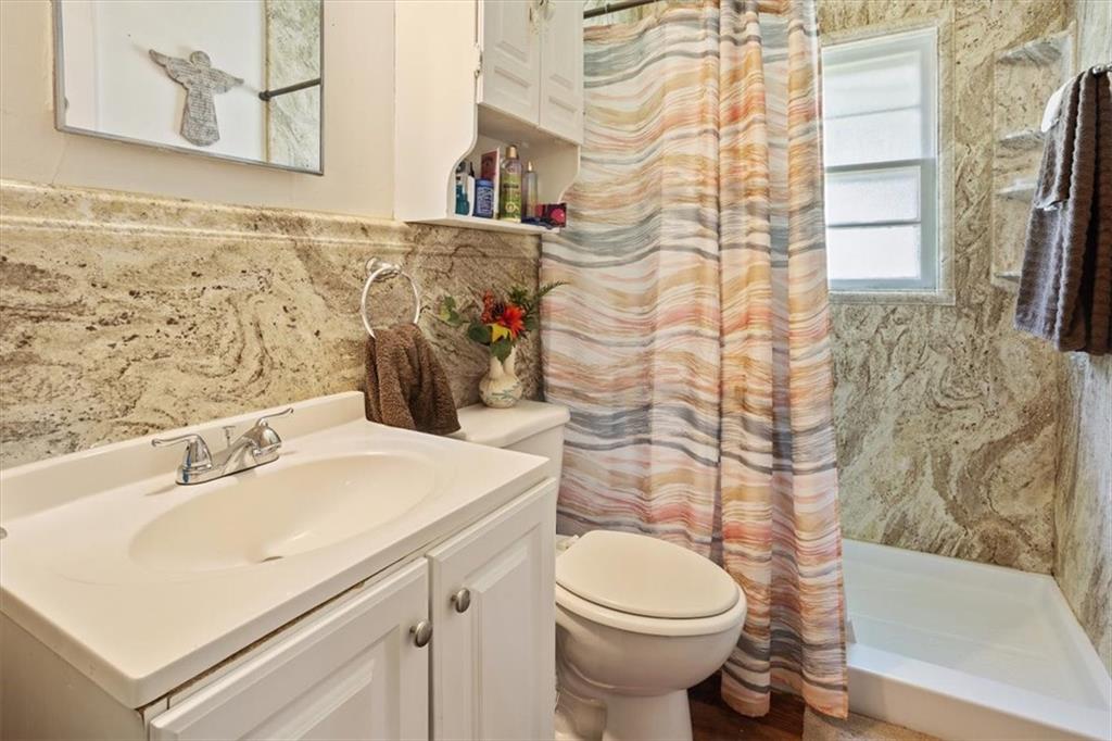 2523 Maple Road Southeast Rome, GA 30161 - Photo 18 of 30 a bathroom with a sink a toilet and shower curtain