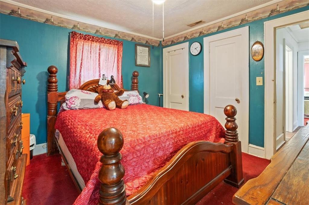 2523 Maple Road Southeast Rome, GA 30161 - Photo 19 of 30 a bed sitting in a bedroom next to a window