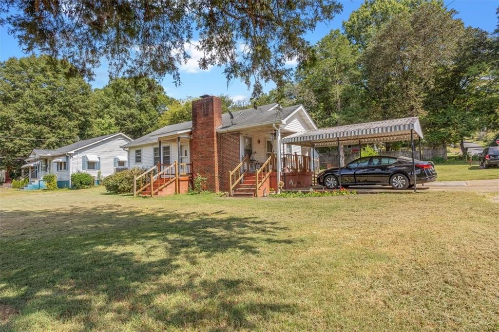 2523 Maple Road Southeast Rome, GA 30161 - Photo 5 of 30 a front view of a house with a garden and trees