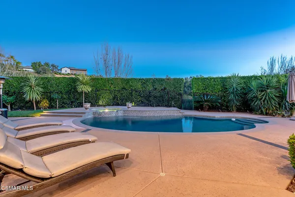 a view of patio with couches and pool