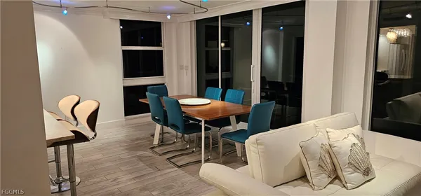 a living room with furniture a rug and a mirror