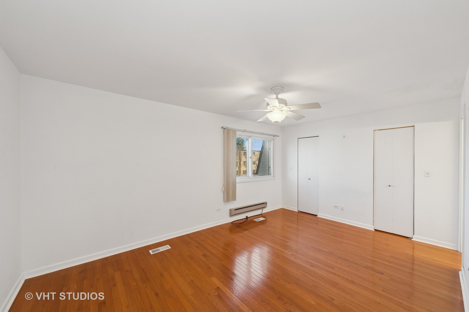 307 Pin Oak Drive Wilmette, IL 60091 - Photo 11 of 18 a view of a big room with wooden floor and chandelier fan