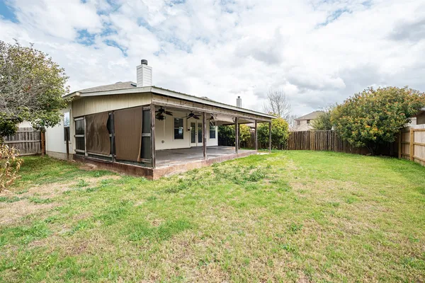 a view of house with yard and entertaining space