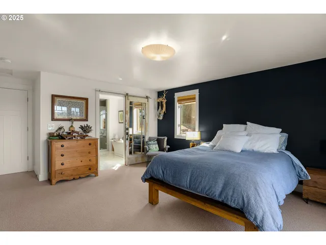 a bedroom with a bed and with furniture