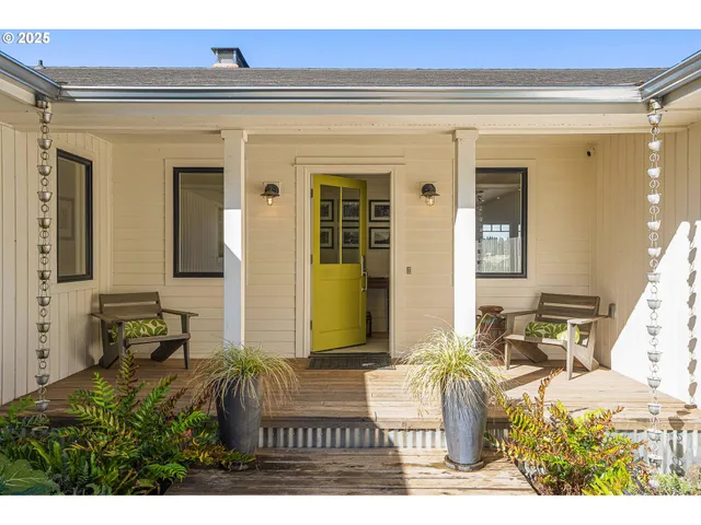 a front view of a house with outdoor seating