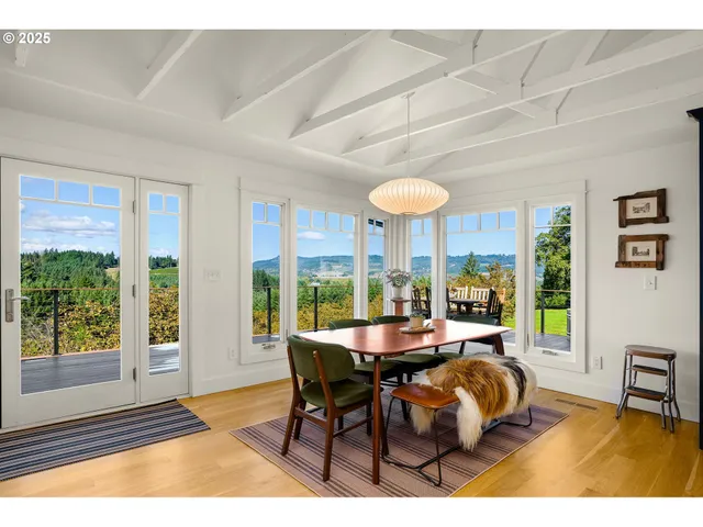 a dining room with furniture and a large window