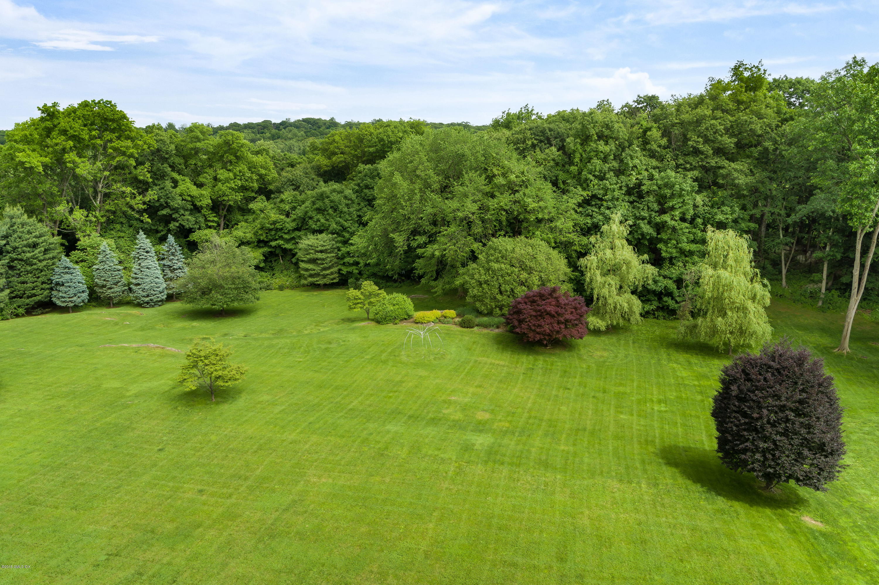 491 Riversville Road Greenwich, CT 06831 - Photo 11 of 30 a green field with lots of trees in it