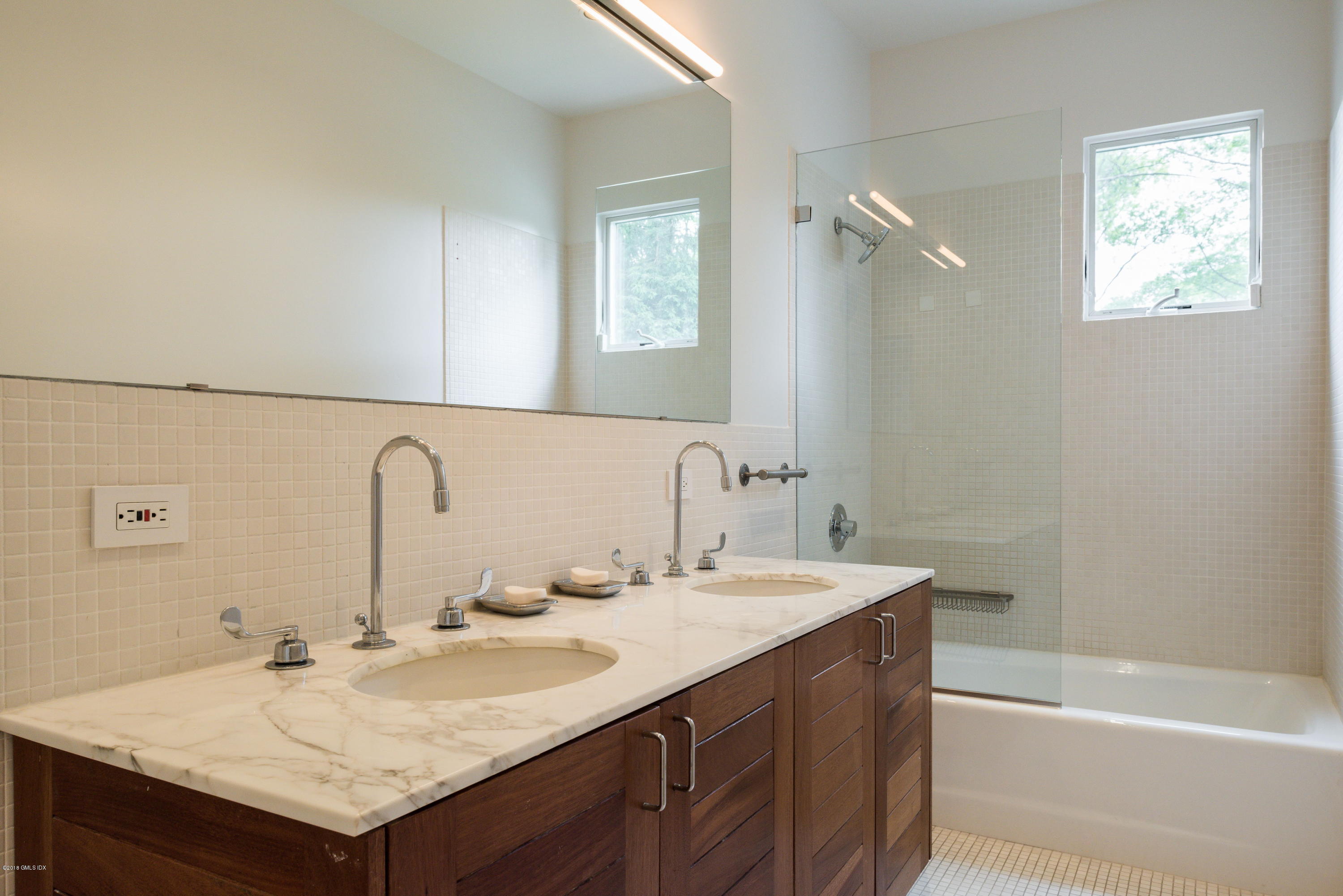 491 Riversville Road Greenwich, CT 06831 - Photo 21 of 30 a bathroom with a sink and a mirror
