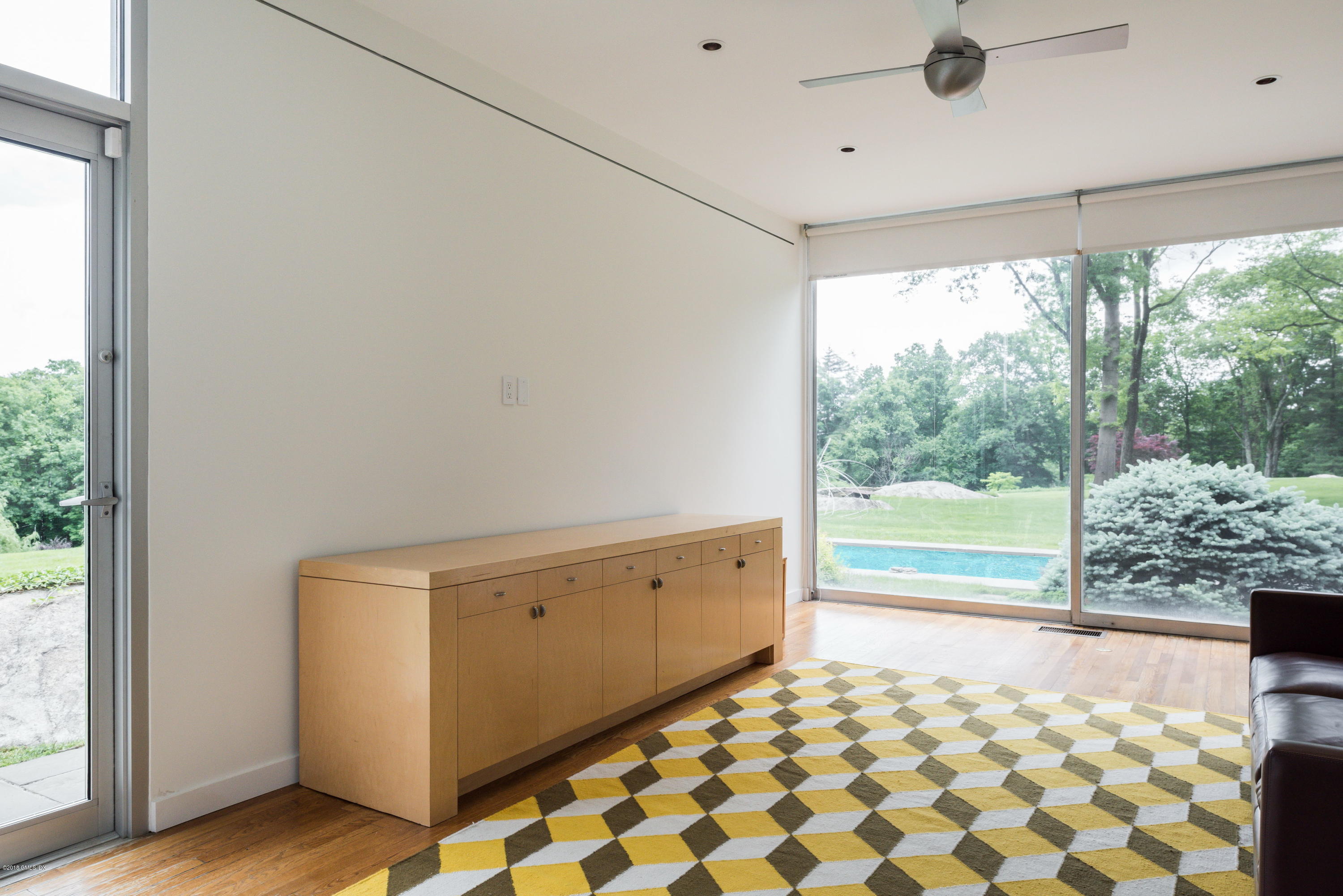 491 Riversville Road Greenwich, CT 06831 - Photo 22 of 30 a view of empty room with wooden floor and fan